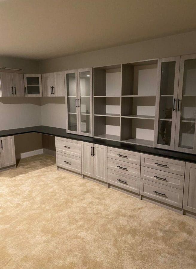 L-shaped home office with lower cabinets and glass uppers