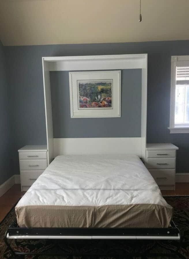 White custom Murphy bed folded down between two nightstand cabinets