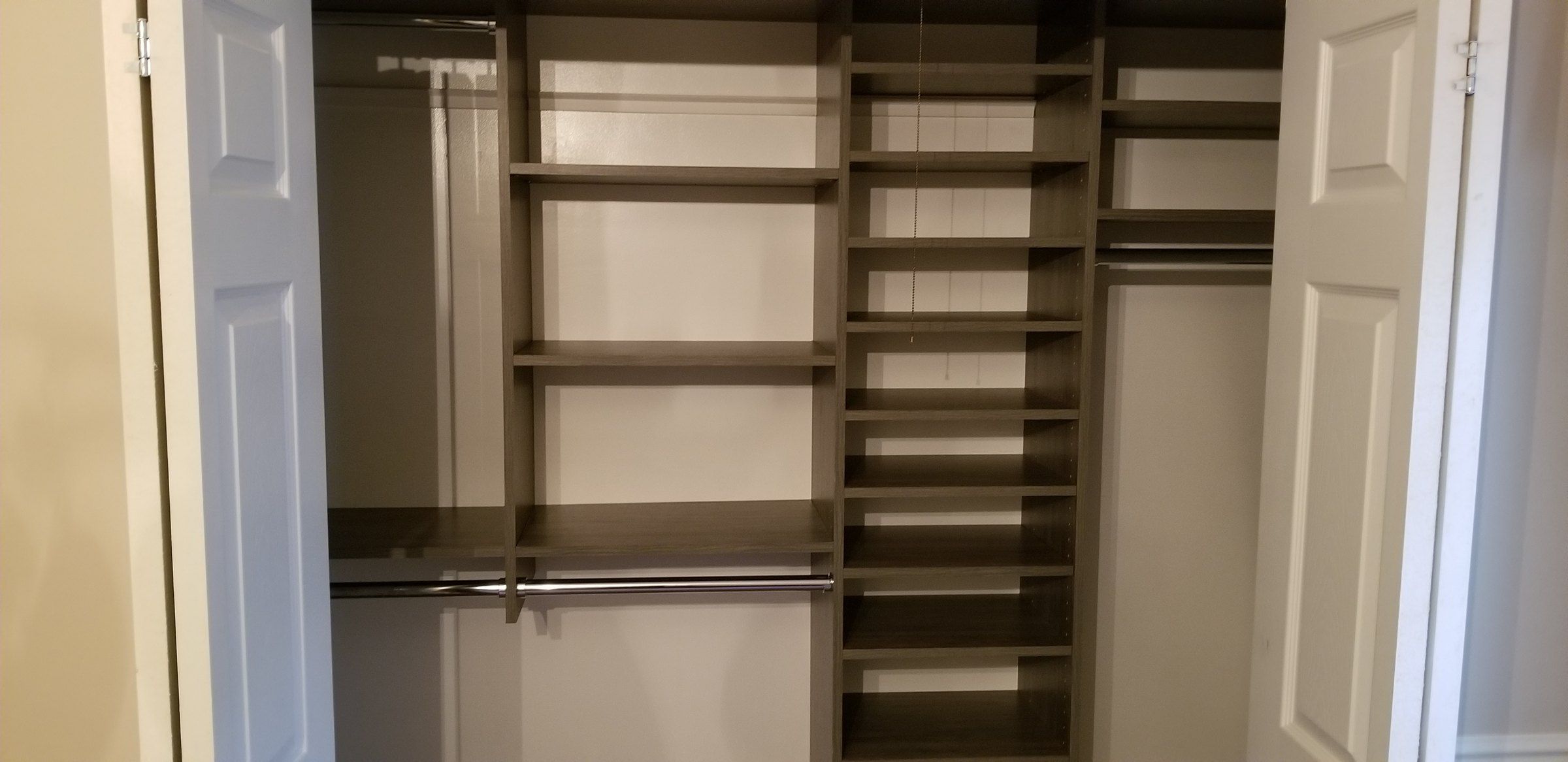 Espresso reach-in closet behind double doors