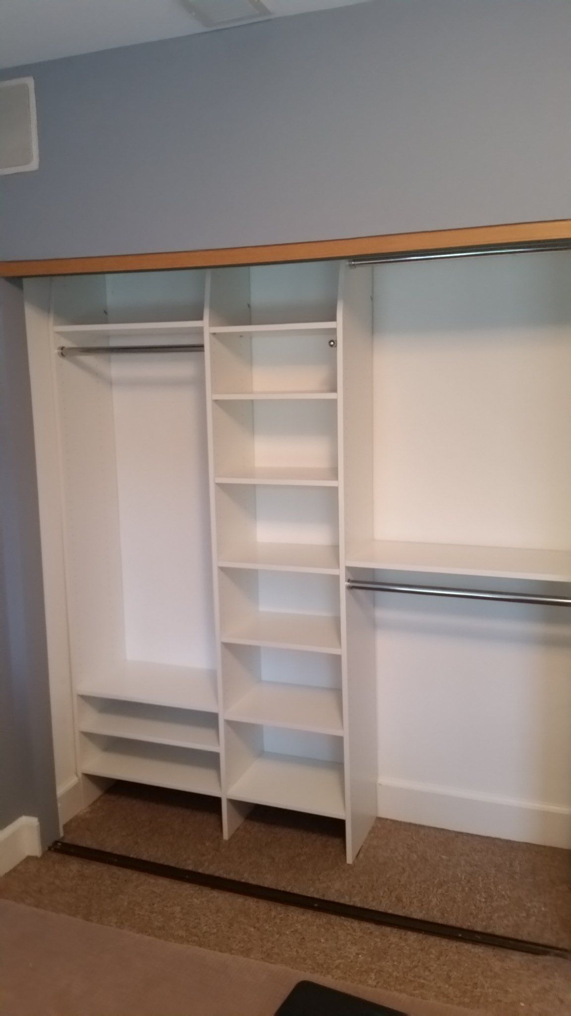 Reach-in closet with shoe shelves between double-hang sections