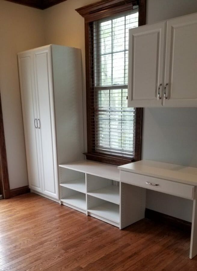 White home office desk and storage beside a window