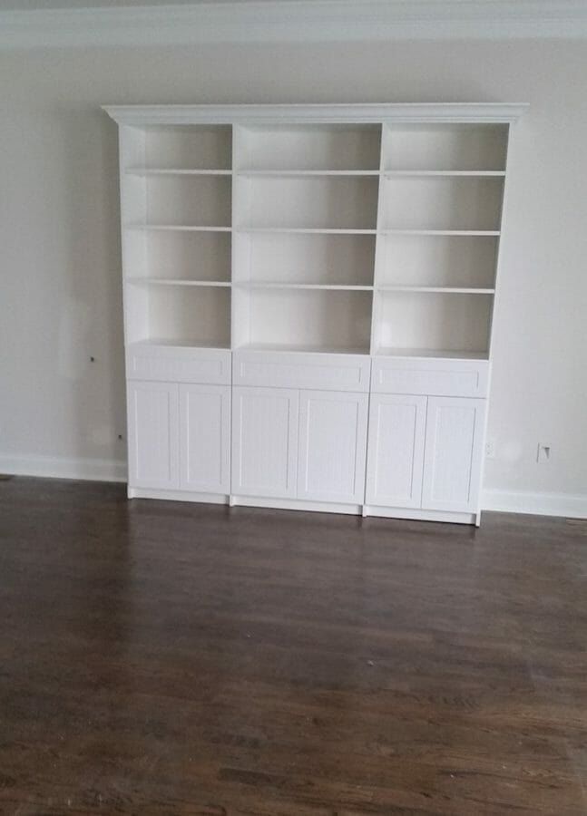 White built-in bookcase wall unit with lower cabinets